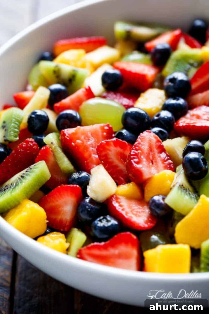 Sweet and Tangy Honey Lime Fruit Salad 4 Side view of a colorful Honey Lime Fruit Salad, showing the variety of fresh fruits and the glistening dressing, ready to be served.