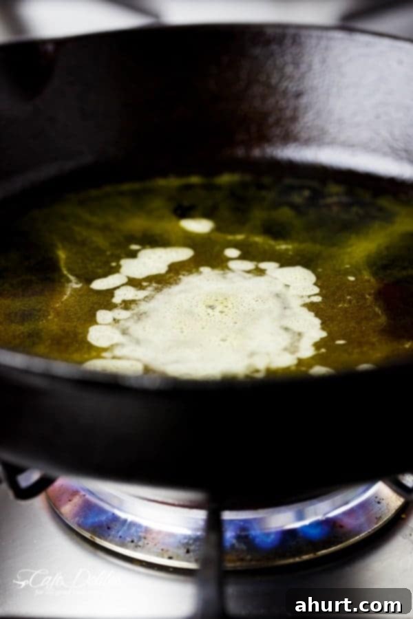 Butter melting and beginning to brown in a hot skillet, ready for honey garlic shrimp.