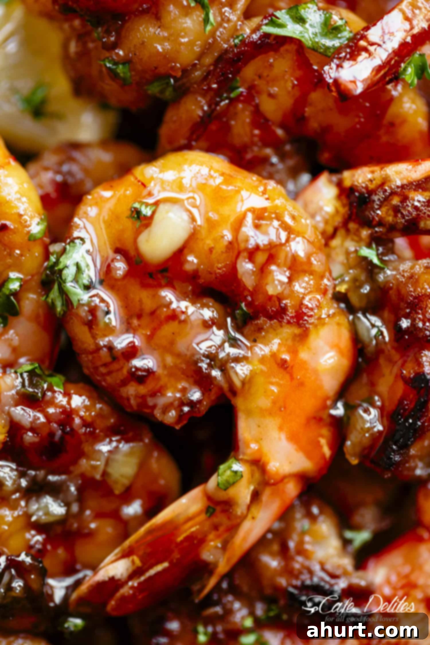 Close-up of golden-browned butter honey garlic shrimp in a skillet, showcasing the delicious glaze.