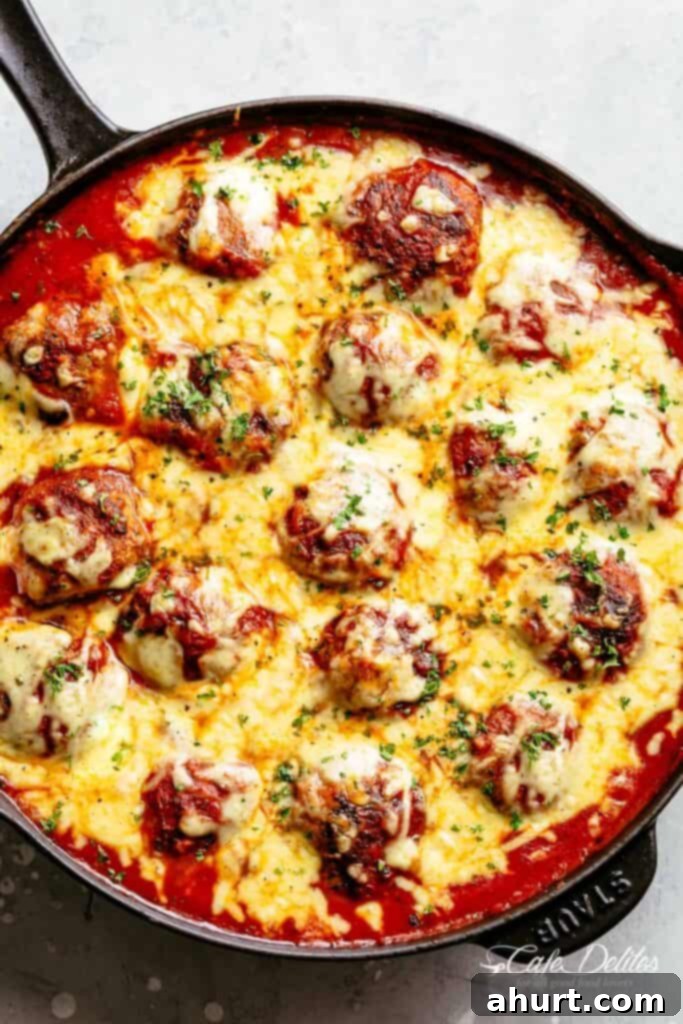 Irresistible Cheesy Meatballs 2 Cheesy Meatballs are soft, juicy and tender, simmered in a rustic homemade tomato sauce. Topped with melted mozzarella cheese and serve over spaghetti