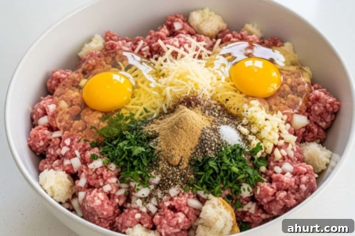 Irresistible Cheesy Meatballs 6 Add all of the meatball ingredients in the bowl with the soaked bread and mix well.