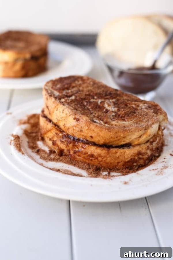 Nutella Stuffed Churro French Toast on a plate