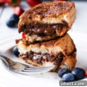 Decadent Nutella Stuffed Churro French Toast 8 Nutella Stuffed Churro French Toast stack on each other
