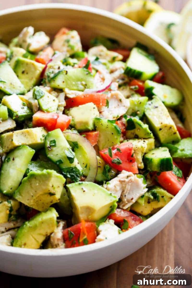 No-Cook Chicken Avocado Cucumber Salad 4 Side angle shot of Quick And Simple Chicken Cucumber Avocado Salad in a rustic bowl