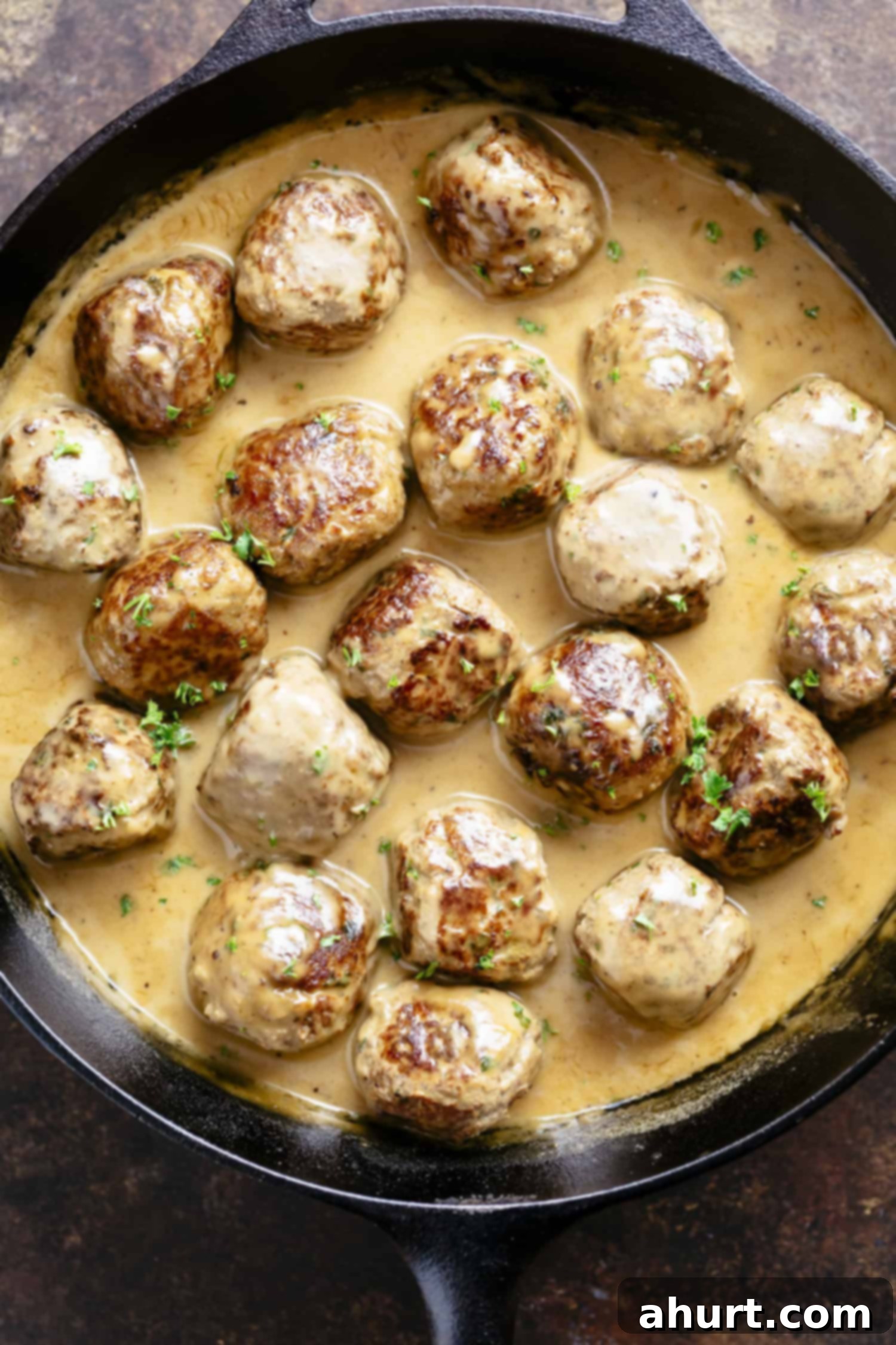 A serving of the best Swedish meatballs in a pot, glistening with creamy gravy, ready to be enjoyed.