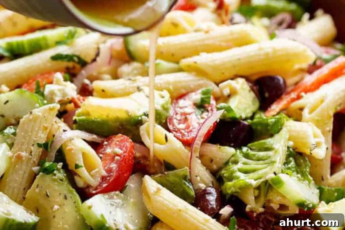 Zesty Mediterranean Pasta Salad 7 Mediterranean Pasta Salad drizzled with dressing.