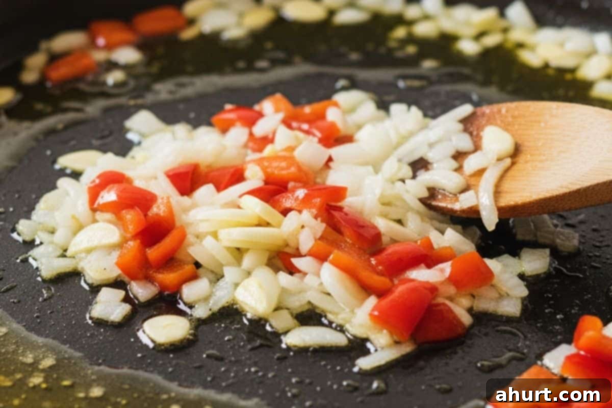 Paella Perfection 4 Add the onion, garlic, and diced red capsicum and cook in a paella pan.