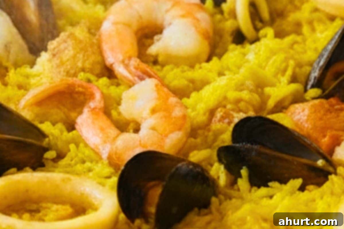 Paella Perfection 9 :Once the rice is nearly cooked, gently fold in the shrimp.