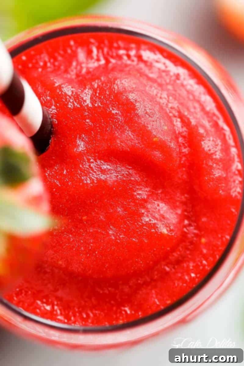 Frozen Strawberry Rosé 3 Top view of Refreshing Strawberry Rosé Slushies in a glass with straw