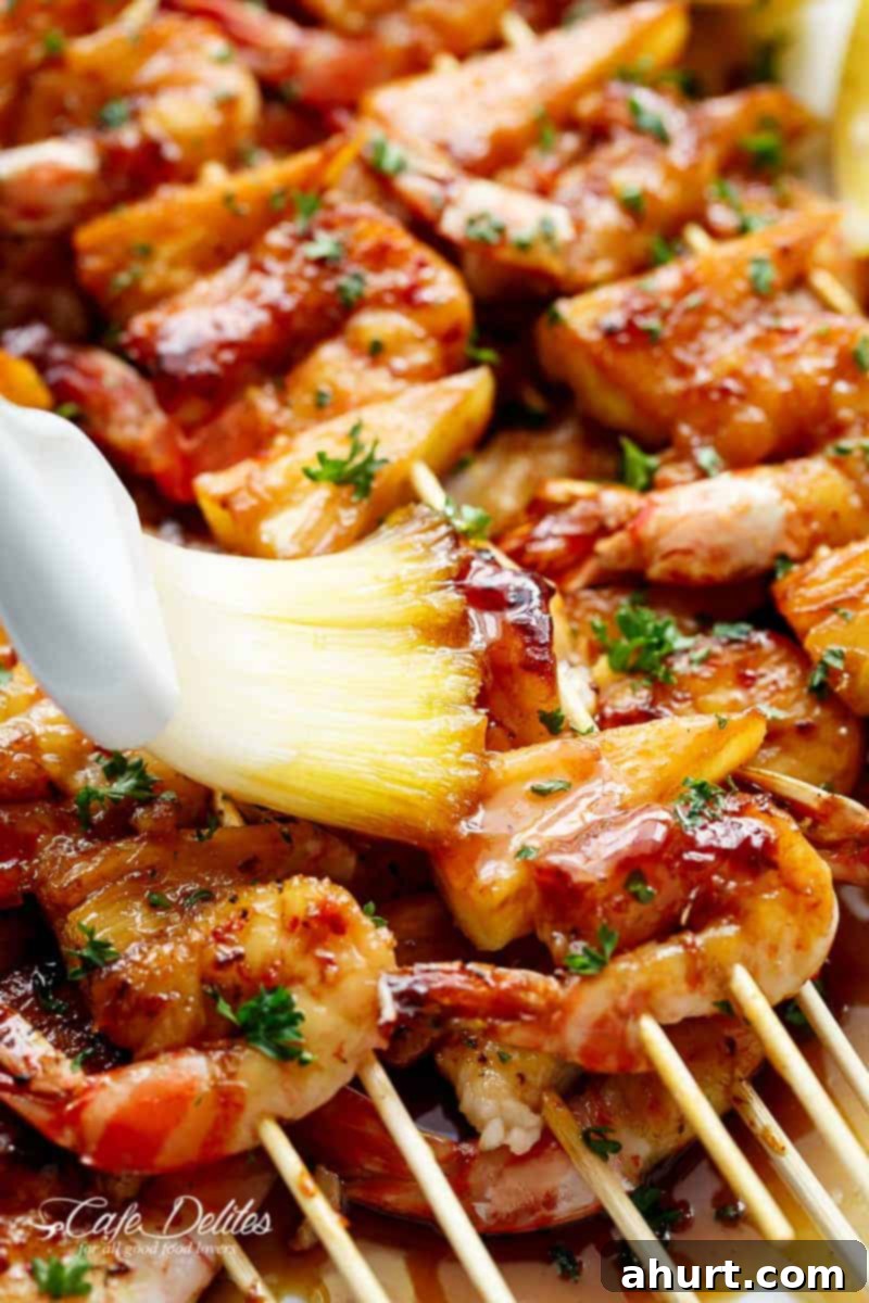 Honey Garlic Glazed Shrimp & Pineapple Skewers 3 Gracing of honey garlic butter sauce over the Shrimp Pineapple Skewers