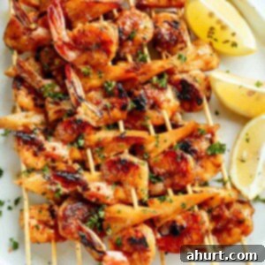 Honey Garlic Glazed Shrimp & Pineapple Skewers 6 Honey Garlic Butter Shrimp Pineapple Skewers are cooked in the most incredible honey garlic butter sauce on a plater