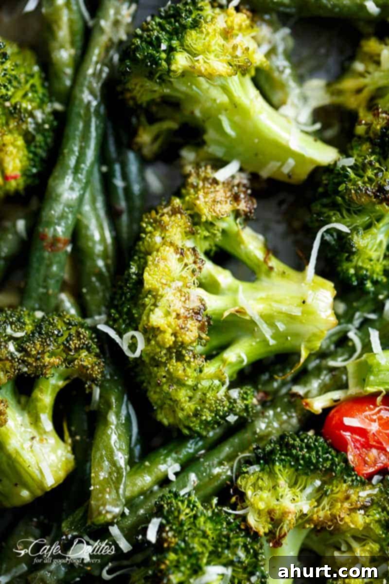 One-Pan Garlic Parmesan Roasted Broccoli and Green Beans 3 Focusing on broccoli piece from Sheet Pan Garlic Parmesan Roasted Broccoli & Green Beans