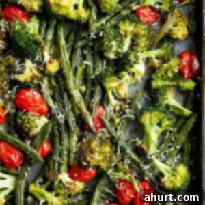 One-Pan Garlic Parmesan Roasted Broccoli and Green Beans 6 Top view of Sheet Pan Garlic Parmesan Roasted Broccoli & Green Beans on a pan