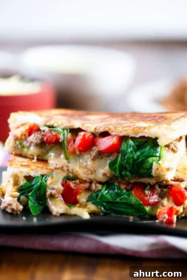 Multiple Loaded Taco Grilled Cheese sandwiches stacked on a wooden platter, ready to serve.