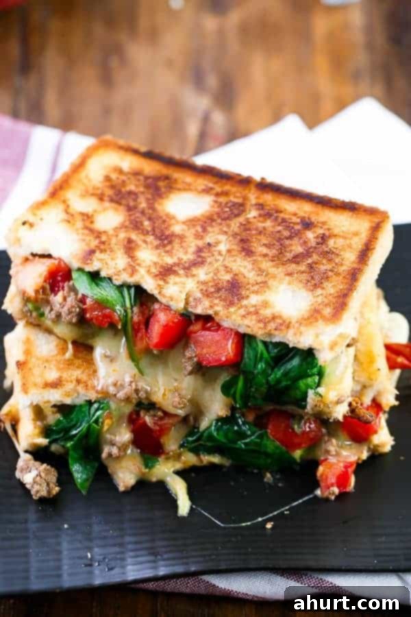 Close-up of a perfectly grilled Loaded Taco Grilled Cheese sandwich, showing its golden-brown crust.