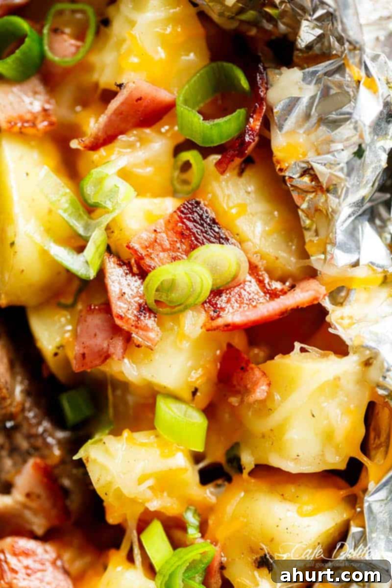 Garlic Butter Steak and Potatoes 3 Image focuses on potato pieces from Steak & Cheesy Bacon Potato Hash Foil Packs