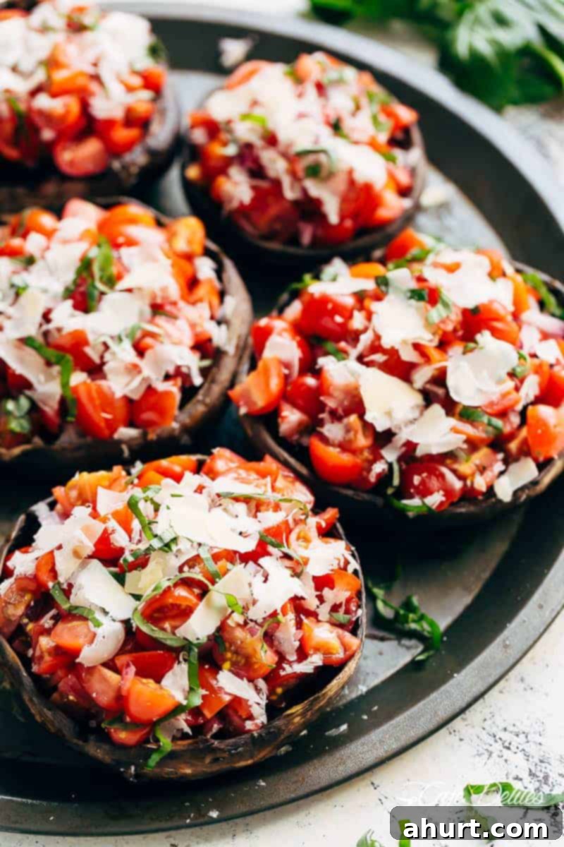 Savory Grilled Portobello Mushroom Bruschetta 2 Grilled Bruschetta Portobello Mushrooms smothered in garlic butter on a round tray
