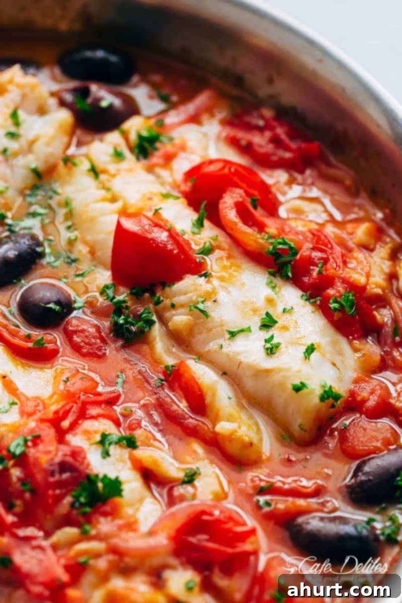 Zoomed-in image of Pan Seared Fish With Tomatoes & Olives, highlighting the texture of the fish and the sauce