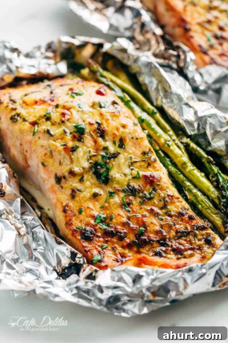 Zesty Lemon Parmesan Salmon and Asparagus Foil Packets 2 Perfectly cooked Lemon Parmesan Salmon & Asparagus Foil Pack, ready to be served, showcasing flaky salmon and tender asparagus, baked or grilled.