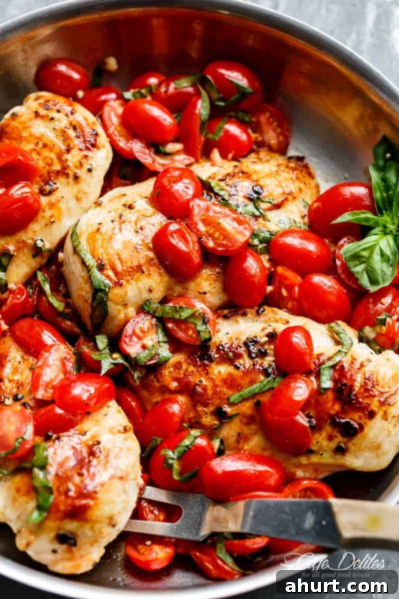 Grape tomatoes burst and cook through a buttery garlic sauce in the Garlic Tomato Basil Chicken 