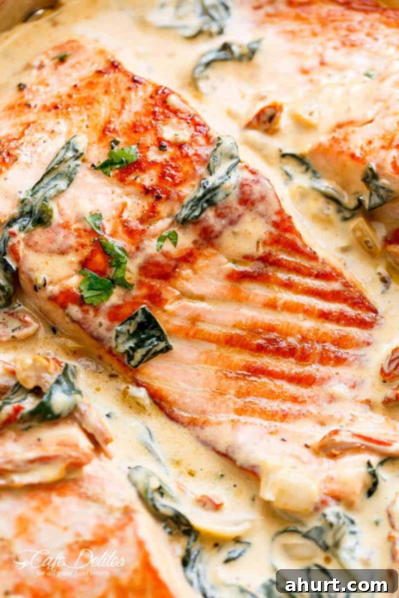 Velvety Tuscan Garlic Butter Salmon 10 Close-up image of garlic butter Tuscan salmon in creamy sauce, garnished with fresh parsley.