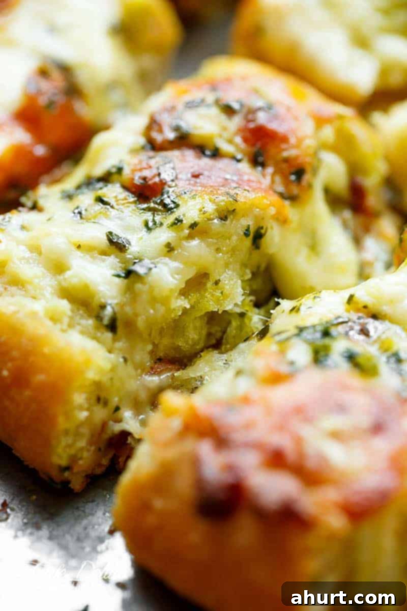 Foolproof Gooey Garlic Cheese Bread 8 Zoom in image of a piece of Easy Cheesy Garlic Bread