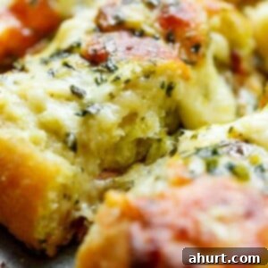 Foolproof Gooey Garlic Cheese Bread 9 Zoom in image of a piece of Easy Cheesy Garlic Bread