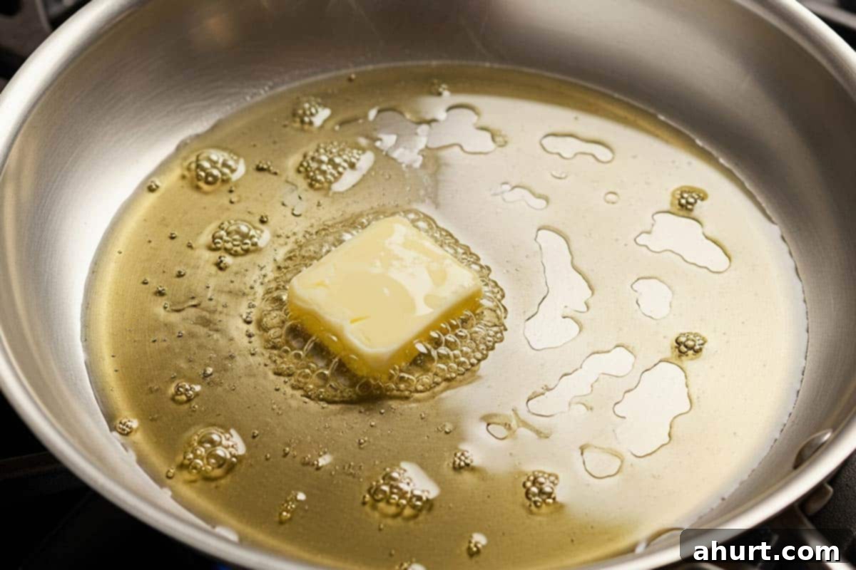 Velvety Chicken Francese 7 Heating unsalted butter and olive oil in a large non-stick skillet over medium-high heat for pan-frying chicken.