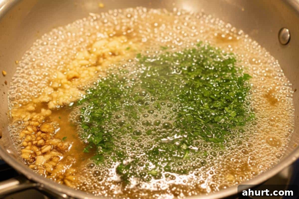 Velvety Chicken Francese 9 Sautéing crushed garlic, then adding dry white wine, chicken broth, and chopped fresh parsley to the pan to reduce for the Creamy Chicken Francese sauce.