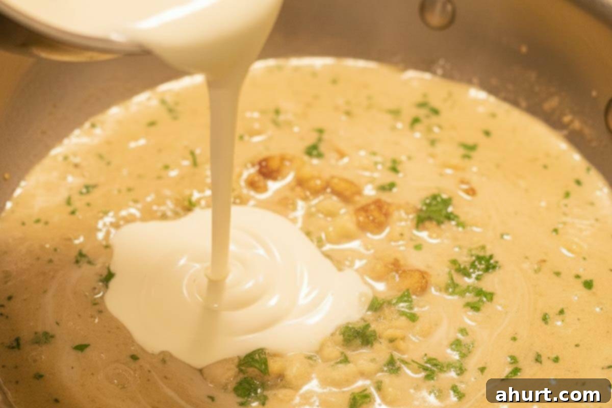 Velvety Chicken Francese 10 Pouring half and half (cream) into the simmering lemon garlic sauce, then letting it gently thicken for the Creamy Chicken Francese.