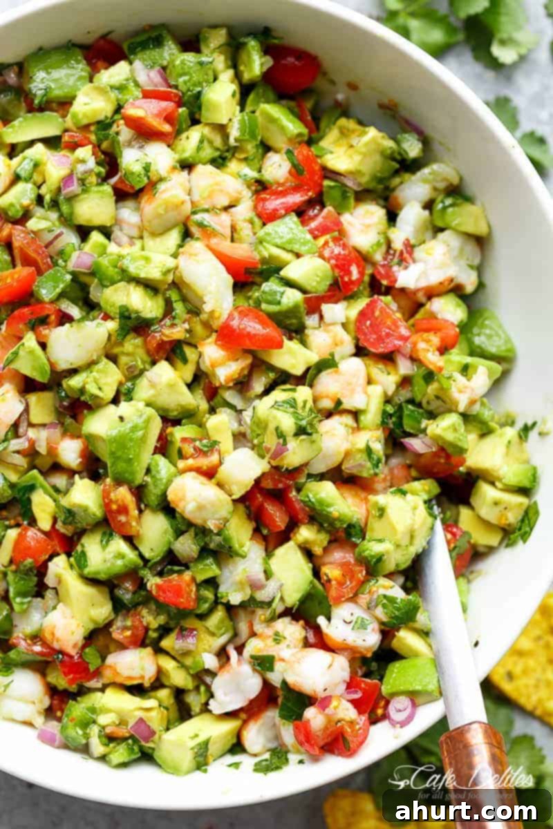 Hearty Shrimp Guacamole 2 Chunky Shrimp Guacamole with spoon in a white bowl