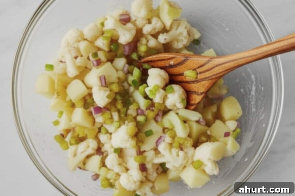 Tangy Bacon Dill Potato Salad 4 In a large mixing bowl, combine the cooled potatoes, cauliflower, red onions, dill pickles, celery, and green onions.