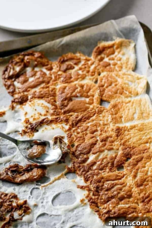 Making of Nutella S'mores Crepes, showing a marshmallow being toasted