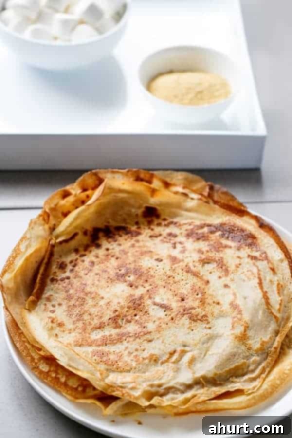 Crepes ready to roll, stacked on a plate