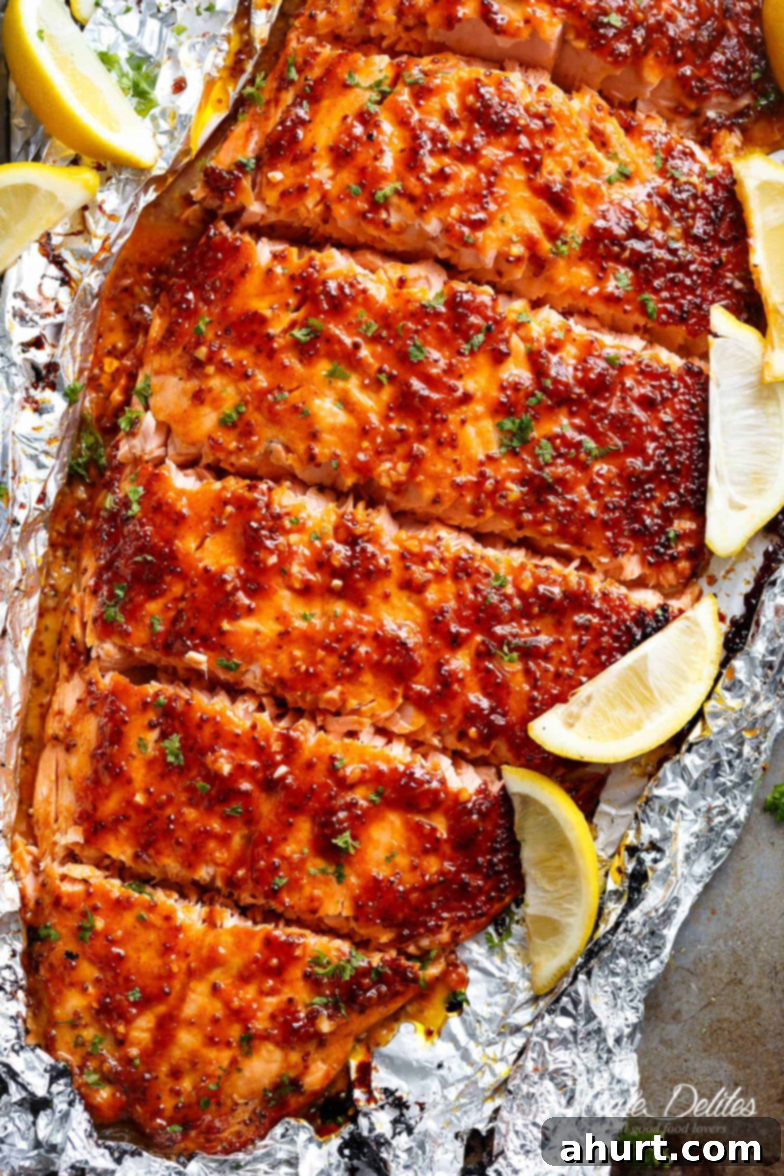 Garlic Butter Honey Mustard Salmon with some lemon wedges In Foil