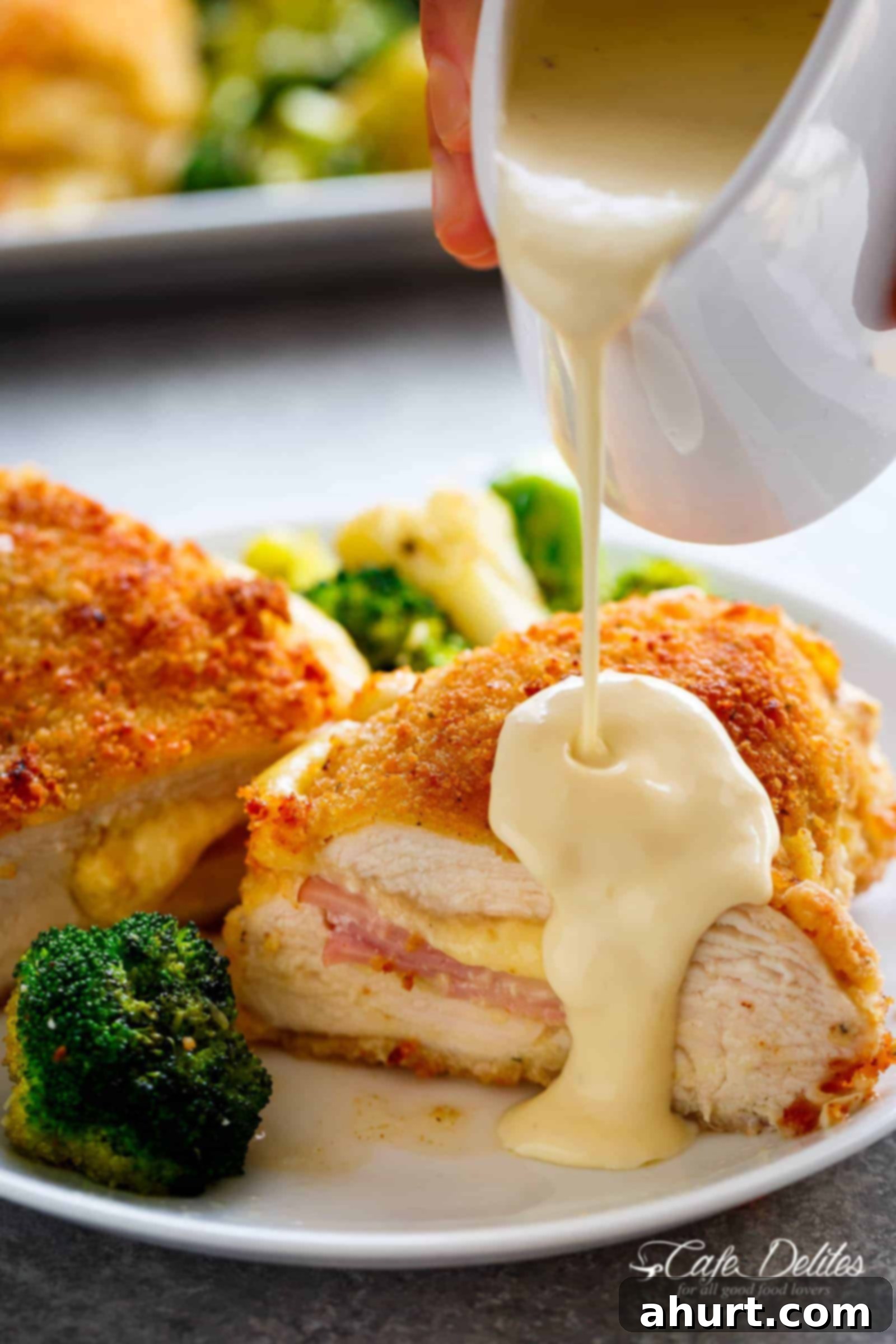 Dijon Cream Sauce pouring on Fried chicken pieces