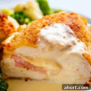 One-Pan Chicken Cordon Bleu with Creamy Dijon Sauce 6 Side view of Crispy crumbed chicken breasts filled with Dijon mustard, Swiss cheese and ham, baked with vegetables and served with an incredible Dijon Cream Sauce