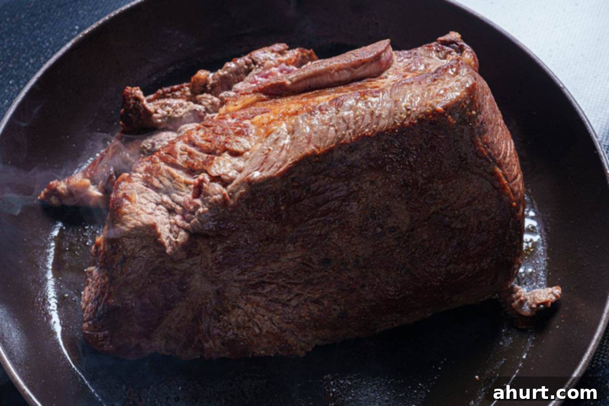 Melt In Your Mouth Pot Roast 5 An image of the beef chuck being seared in the skillet until it is browned.