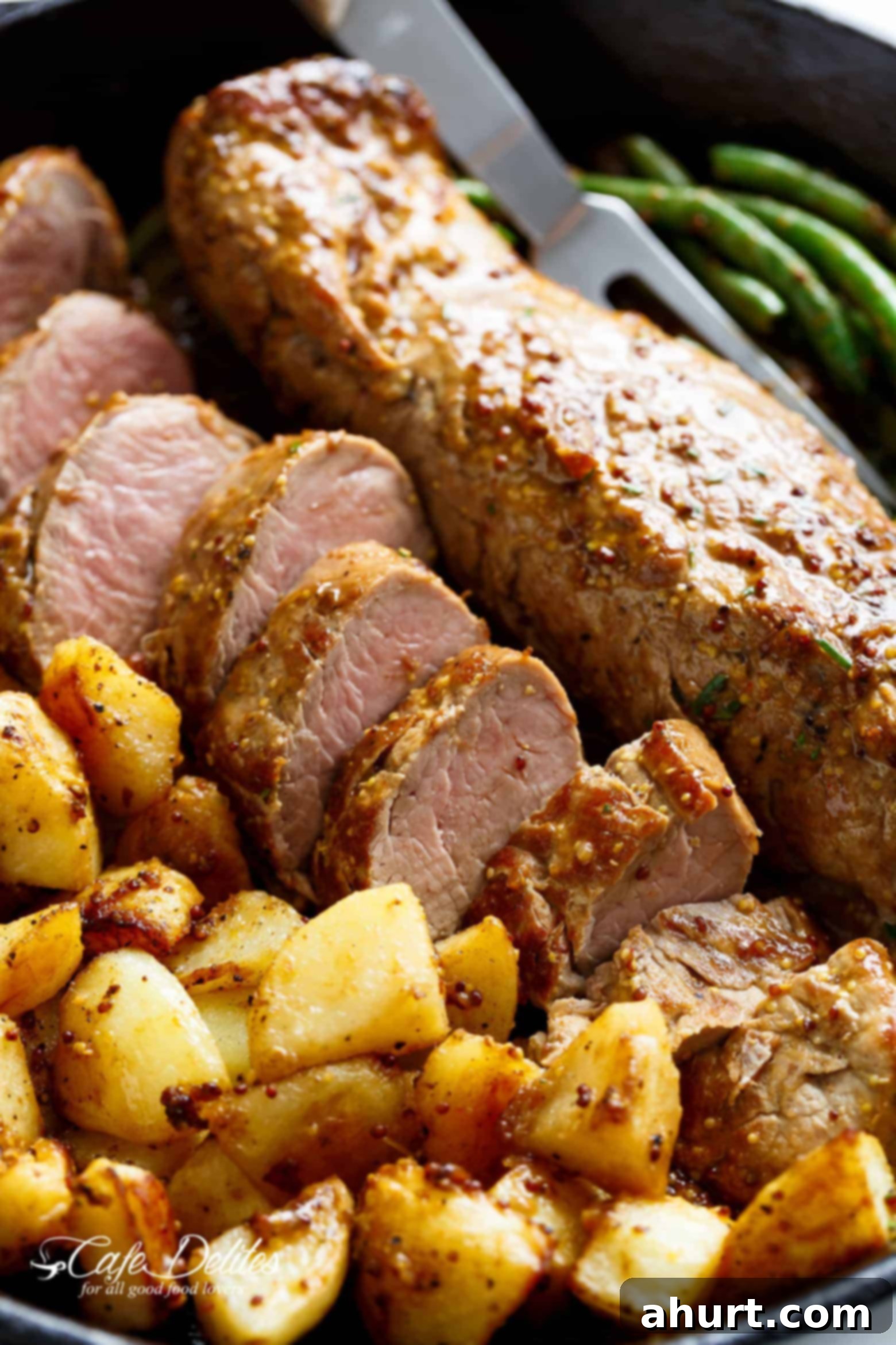 Dijon Pork Tenderloin 3 Dijon Garlic Pork Tenderloin slices & fried potatoes on a plate