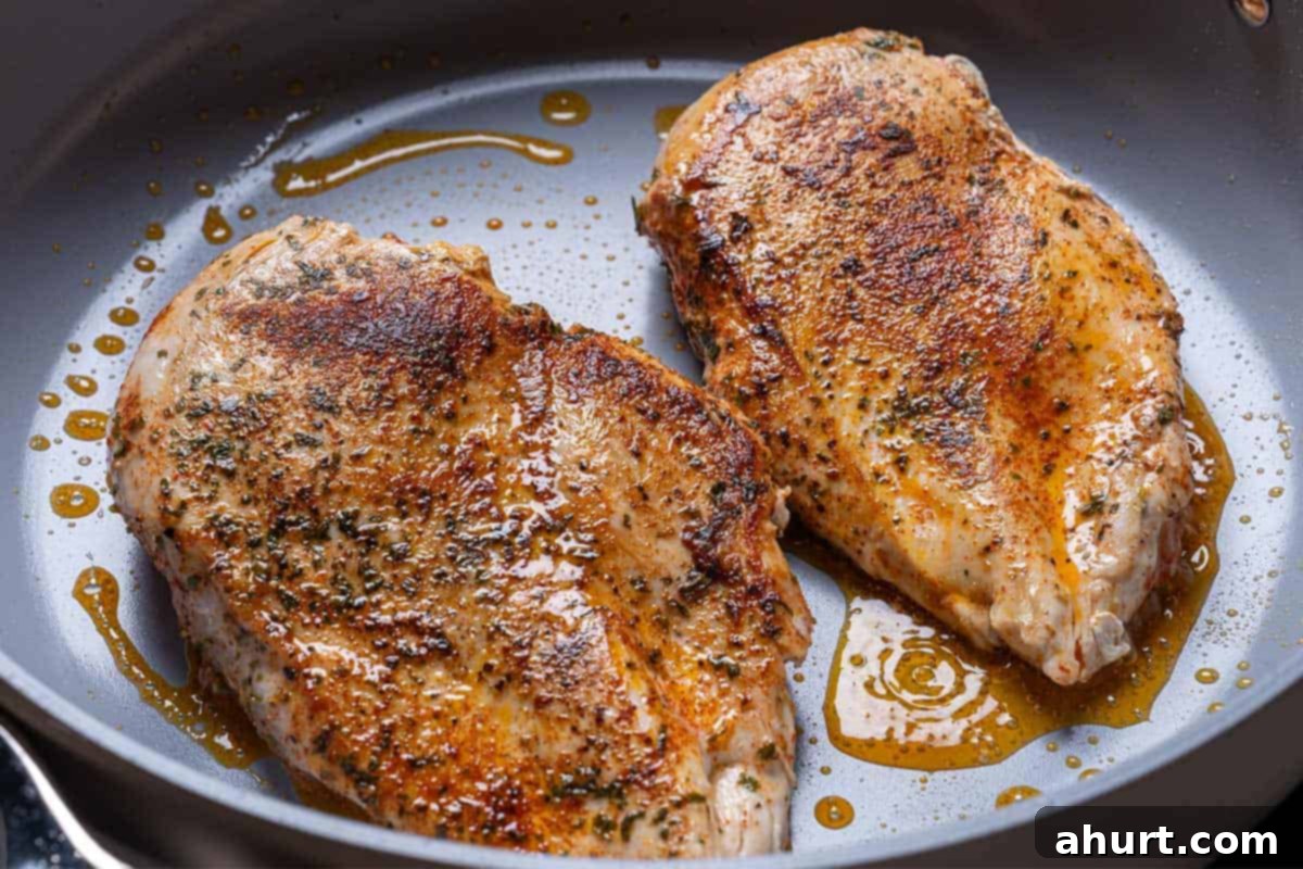 Hearty Tuscan Chicken Skillet Mac 5 Chicken breasts sizzling in the pan, seared to a golden brown perfection and cooked through for tender, juicy bites.