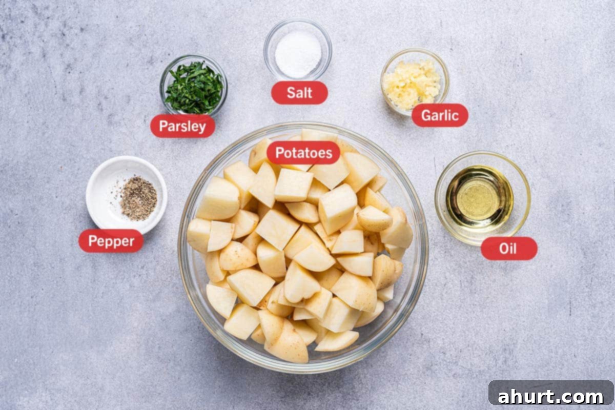 Golden Crispy Garlic Potatoes 3 image of all the ingredients needed for the preparation of garlic roasted potatoes, specifically: potatoes, pepper, parsley, salt, garlic, oil.
