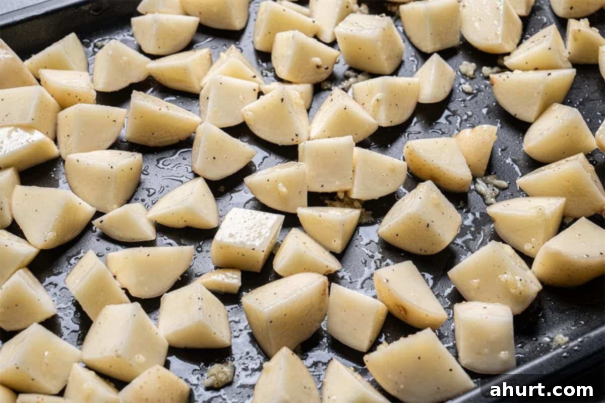Golden Crispy Garlic Potatoes 5 Potatoes arranged on the baking tray in a single layer.