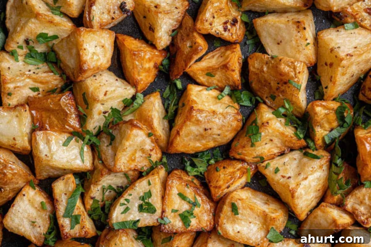 Golden Crispy Garlic Potatoes 7 Top view image of roasted potatoes ready to be served, golden and buttery, sprinkled with fresh parsley.