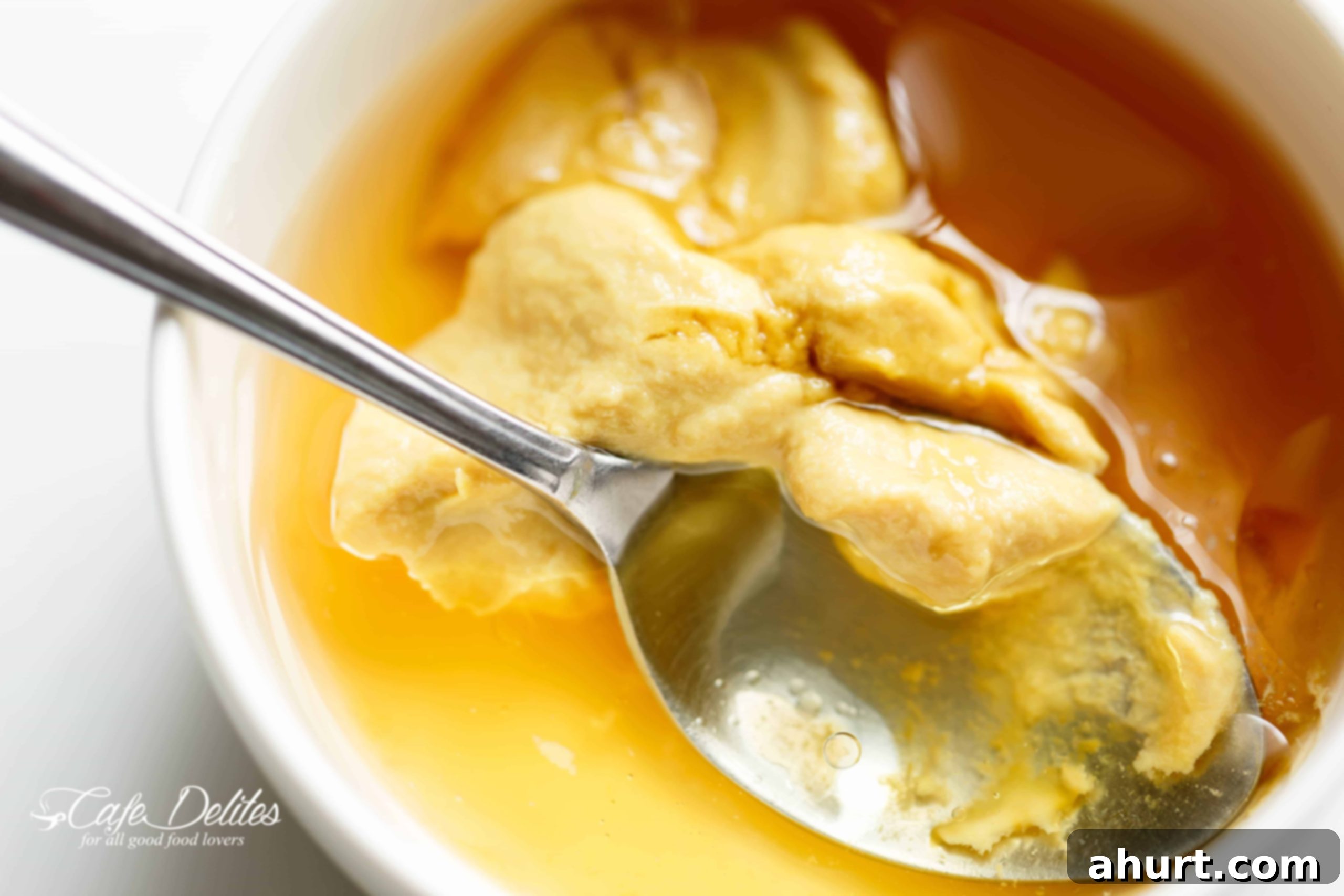 Close-up of ingredients for Honey Dijon Apple Bacon Cranberry Salad being prepared, including fresh spinach, sliced apples, and cranberries.