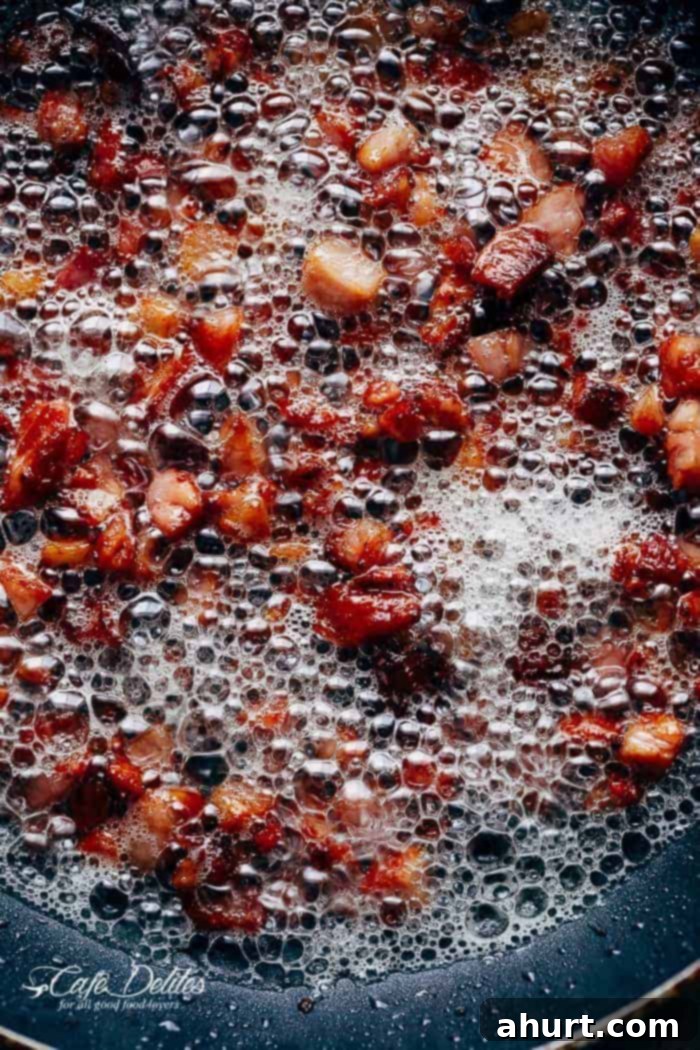 A golden stream of honey being poured from a measuring spoon, highlighting a key ingredient for the Honey Dijon dressing.