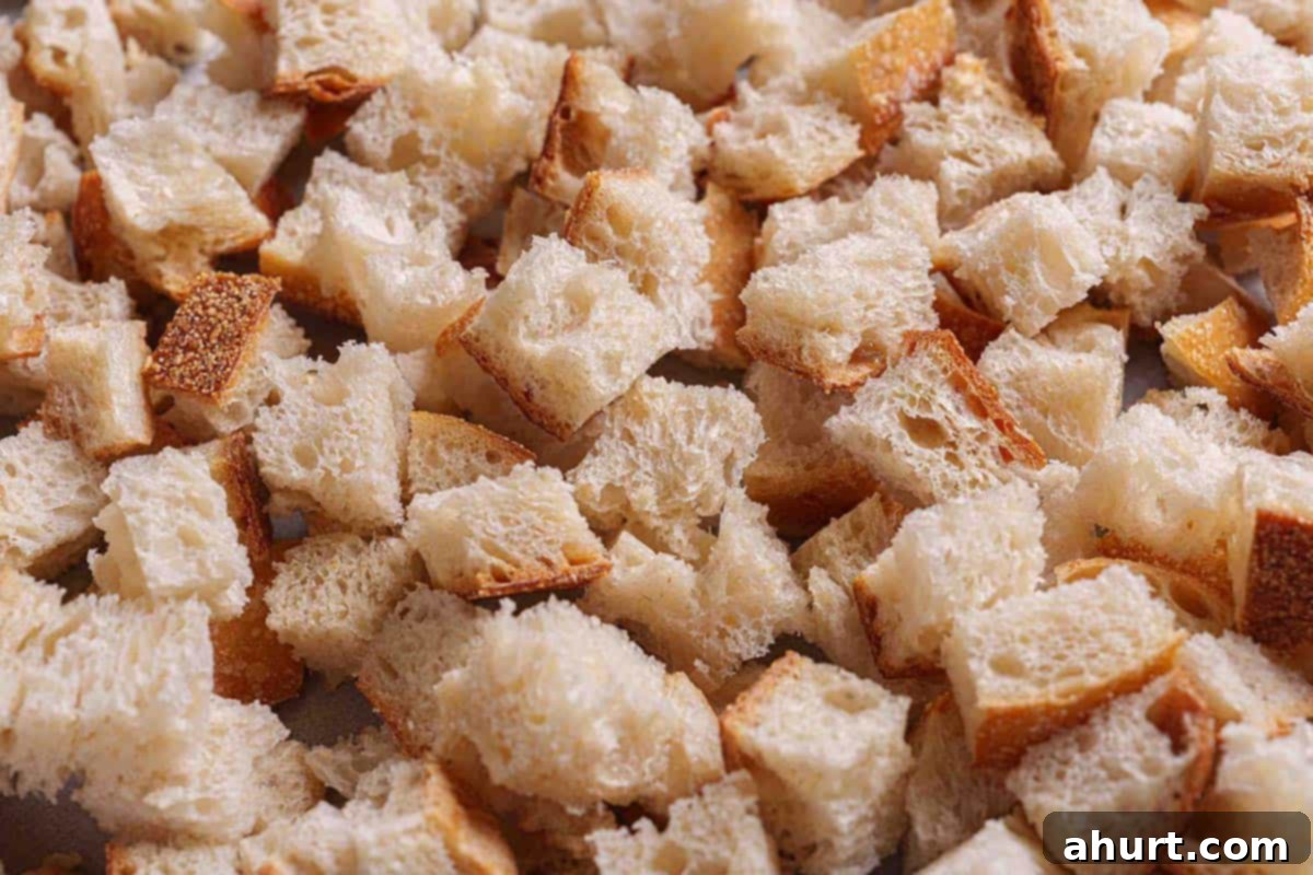 Irresistible Sausage Stuffing 4 Step 1: The image shows finely diced pieces of stale bread ready to be used for making the stuffing.