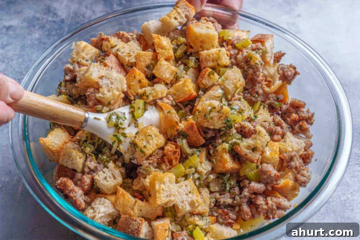 Irresistible Sausage Stuffing 8 Step 5: The image shows the eggs and seasoning being poured over the mixture and stirred in a bowl.