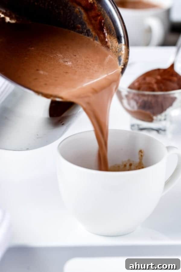 PB Nutella Swirl Hot Cocoa 4 Peanut Butter Nutella Hot Chocolate being poured in a cup