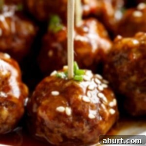 Sticky Teriyaki Meatballs 11 zoom in image of Teriyaki Beef Meatballs picked with toothpick