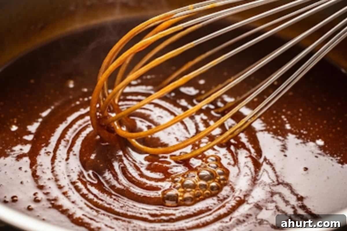 Sticky Teriyaki Meatballs 8 Whisk in sesame oil, garlic, soy sauce, mirin, sake, sugar, and water, then add the cornstarch slurry and simmer until thick and glossy.